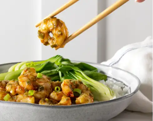 Golden glazed shrimp, tender and glossy with a hint of green onion garnish.