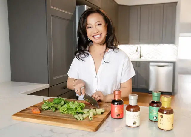 Wooden cutting board with chopped vegetables and a knife on it